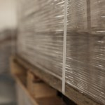 Stacks of Merchandise Wrapped in Stretch Film on Wooden Pallet