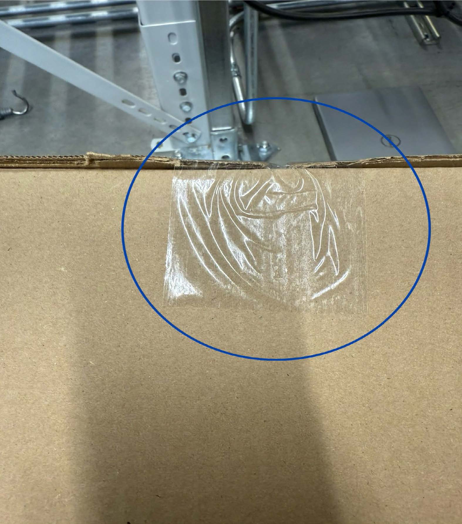 Box sealed with competitor tape, showing wrinkles and bubbles